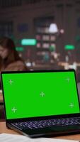 Vertical African american pupil uses green screen extracting citations from specialty books and other reliable academic sources, research tools within the university campus library. Self learning. Camera B. video