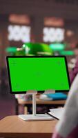 Vertical College student looks at isolated chroma key screen at the campus library, working on a school project and collecting information from academic specialty books. Researching. Camera A. video
