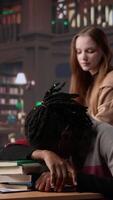 Vertical Person waking up african american girl in the university campus library, student falling asleep on stack of borrowed books. Tired and overwhelmed pupil tries to study all night. Camera B. video