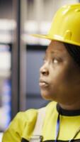 Vertical Solar panels plant engineering team using laptop to oversee machinery systems. Photovoltaics plant teamworking colleagues use software on notebook to maintain operations, camera B video