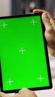 Vertical Solar panels plant technician uses green screen tablet to oversee systems. Photovoltaics plant employee uses software on chroma key device to maintain operations, camera B close up video