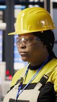 Vertical Portrait of smiling woman in industry 4.0 solar panels plant producing renewable energy. Jolly engineer in photovoltaics smart factory analyzing data, reviewing system metrics, camera B video