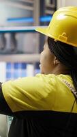 Vertical IT staff members overseeing solar panel production lines equipment. Coworkers doing brainstorming, maintaining photovoltaic assembly systems in automated industry 4.0 factory, camera B video