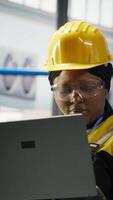 Vertical Technician inspecting solar panels production line, analyzing equipment performance, maintaining photovoltaics assembly systems in automated eco friendly factory, camera B video