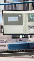 Vertical Robotics software on screen in smart factory used to inspect machinery for operational integrity. Monitor in industry 4.0 industrial plant equipped with advanced sensors overseeing gear, panning shot video