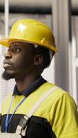 Vertical Technician holding toolbox walking in factory, overseeing solar panel production lines equipment. Engineering expert maintaining photovoltaic assembly systems in automated industrial plant, camera B video