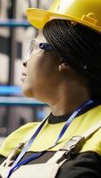 Vertical Solar panels plant expert uses tablet to oversee systems, ensuring machinery operates at optimal efficiency. Photovoltaics plant employee uses device software to maintain operations, camera B close up video