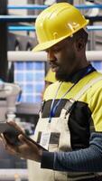 Vertical Smart factory mechanic testing automated systems, doing preventive maintenance. Industry 4.0 plant repairman inspecting equipment to identify and service glitches, camera B video