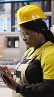 Vertical Expert using tablet to conduct routine inspections in industry 4.0 plant producing renewable energy. Photovoltaics smart factory employee testing equipment using device, camera A video