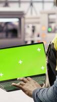 Vertical Solar panels factory engineer analyzes performance data with green screen laptop to predict gear failures. Photovoltaics plant worker uses mockup notebook to follow maintenance procedures, camera B video