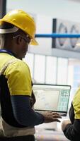 Vertical Engineering team working together to conduct routine inspections in industry 4.0 plant producing renewable energy. Photovoltaics smart factory teamworking colleagues testing equipment, camera B video