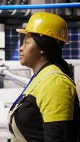 Vertical Technician walking in smart factory, inspecting systems, ensuring machinery operates at optimal efficiency. Industry 4.0 plant mechanic overseeing equipment, maintaining continuous operations, camera A video