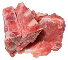 A cut section of raw pork bones with some attached meat and fat, isolated background. photo