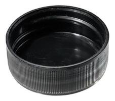 A round, black plastic bottle cap with a ribbed exterior and a smooth inner surface, isolated background photo
