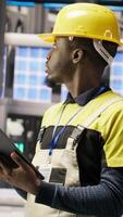 Vertical Smart factory specialist testing automated systems, monitoring operational integrity. Industry 4.0 plant technician inspecting equipment to identify and repair damages, camera B video