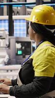 Vertical Engineer in photovoltaics factory using PC display to look at system performance metrics. Worker in industry 4.0 plant using computer screen to track energy production through IoT sensors, camera A video