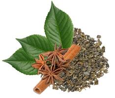 A pile of dry, rolled green tea leaves is arranged with three star anise, a cinnamon stick, and three green leaves, isolated background. photo