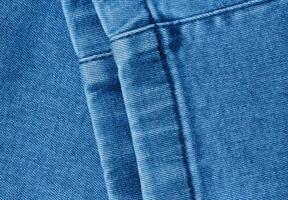 Fragment of the bottom of a pair of blue jeans with a decorative seam photo