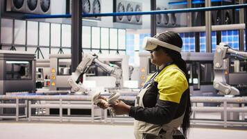 Engineer working in industry 4.0 plant using virtual reality technology to check equipment. Smart factory employee using VR headset to manage and upgrade automation systems, camera A video