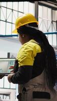 Vertical Engineering team working together to conduct routine inspections in industry 4.0 plant producing renewable energy. Photovoltaics smart factory teamworking colleagues testing equipment, camera A video