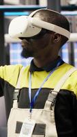 Vertical Engineer in smart factory does maintenance using VR headset tech. Industry 4.0 plant worker managing operational reliability of photovoltaic systems using virtual reality technology, camera B video