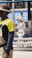 Vertical Engineer in smart factory does maintenance using VR headset tech. Industry 4.0 plant worker managing operational reliability of photovoltaic systems using virtual reality technology, camera A video
