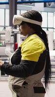Vertical Photovoltaics smart factory specialist fixing damaged IoT sensors using VR tech. Mechanic in industry 4.0 solar panels plant using innovative virtual reality tech to find and fix errors, camera A video
