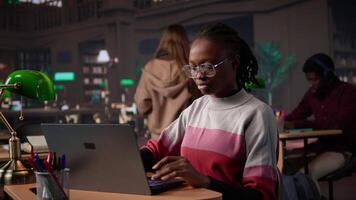 Young black learner focusing on literature assignment by gathering data from the database at the university library, using research tools to gather more academic information. Camera B. video
