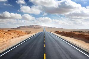 A long road stretching into the horizon in a desert landscape with a clear sky, representing freedom, travel, and adventure photo