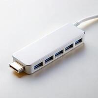 White USB hub with several USB ports and a USB Type C connector, device for expanding connection options for laptops or computers photo
