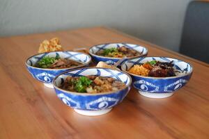 a beautiful assortment of Japanese rice and noodle bowls arranged neatly on a wooden table photo