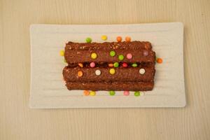 The chocolate bars appear rich and textured, possibly containing nuts or crispy rice photo