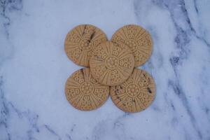 The cookies feature a delicate embossed floral pattern on top photo