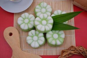 These cakes are shaped like flowers and have a two toned color scheme white on top and light green at the bottom photo