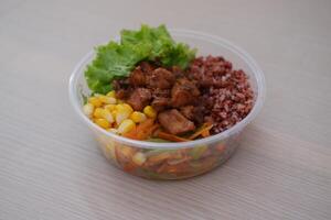 a nutritious meal served in a transparent plastic bowl, ideal for takeaway photo