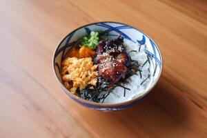 a beautifully presented bowl of Japanese-style rice topped with a variety of colorful and appetizing ingredients photo
