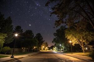 a street at night with street lights and stars photo