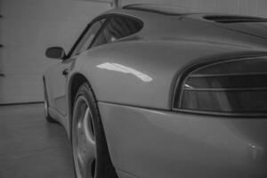 a black and white photo of a sports car