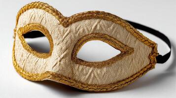 A Venetian mask featuring intricate floral patterns and delicate gold trim, creating an air of mystery and elegance, isolated on a crisp white background. photo