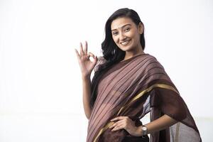 Beautiful Woman Portrait Showing Ok Gesture Smiling Looking At Camera photo