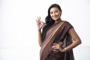 Portrait Of A Young Lady Smiling And Showing Ok Gesture In Camera photo
