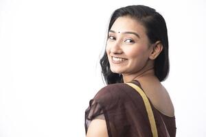 Young Model Smiling At The Camera While Wearing Sari And Standing In The Studio photo