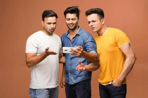 Indian male models got upset while watching a live cricket game on their mobile device due to the loss of a wicket. photo