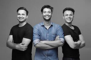 Grayscale photo of smiling young models posing in front of the camera