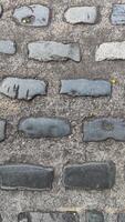 stone pavement tiles arranged neatly, showing a uniform pattern and natural texture photo