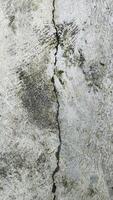 Close-Up of Rough Cracked Cement Surface Showing Detailed Texture and Natural Patterns photo