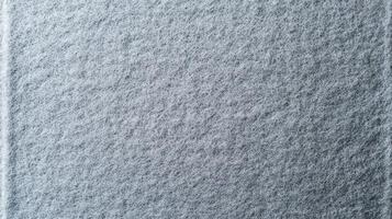 Close Up Gray Felt Texture Surface showing tangled synthetic fibers with porous structure and fine thread pattern resembling industrial felt for textile or material design backgrounds. photo