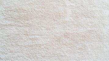 Soft beige towel fabric texture close up showing detailed loops and absorbent surface ideal for home textile and cleanliness concepts. photo