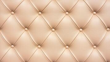 Beige leather upholstery with button tufting and diamond stitching creating a luxurious textured surface for furniture design. photo