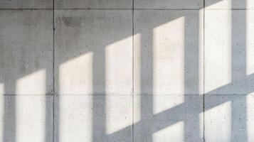 Concrete Wall With Harsh Window Shadows featuring grid-like panel lines and strong directional sunlight casting diagonal shapes across the rough surface. photo